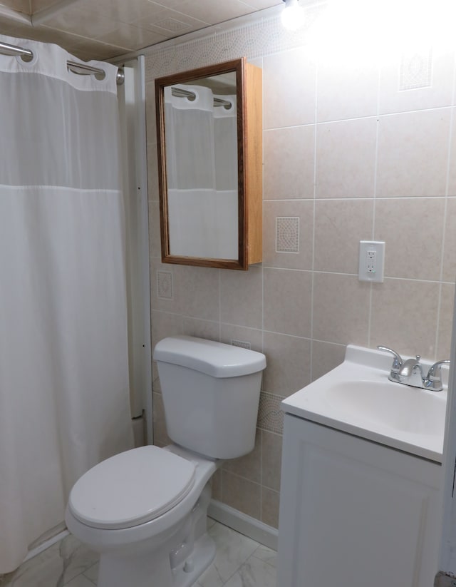 bathroom with marble finish floor, vanity, a shower with shower curtain, and toilet