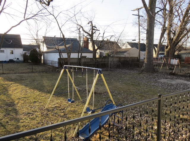 view of yard with a playground and a fenced backyard