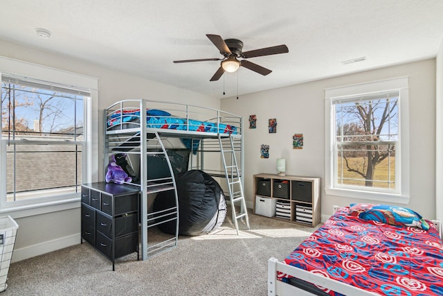 bedroom featuring visible vents, multiple windows, and carpet