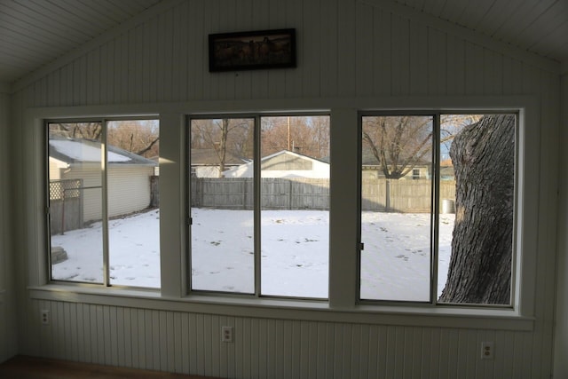 unfurnished sunroom with lofted ceiling