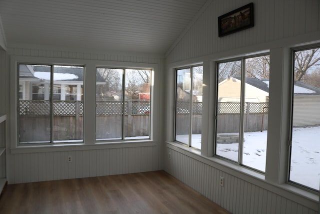 unfurnished sunroom featuring lofted ceiling