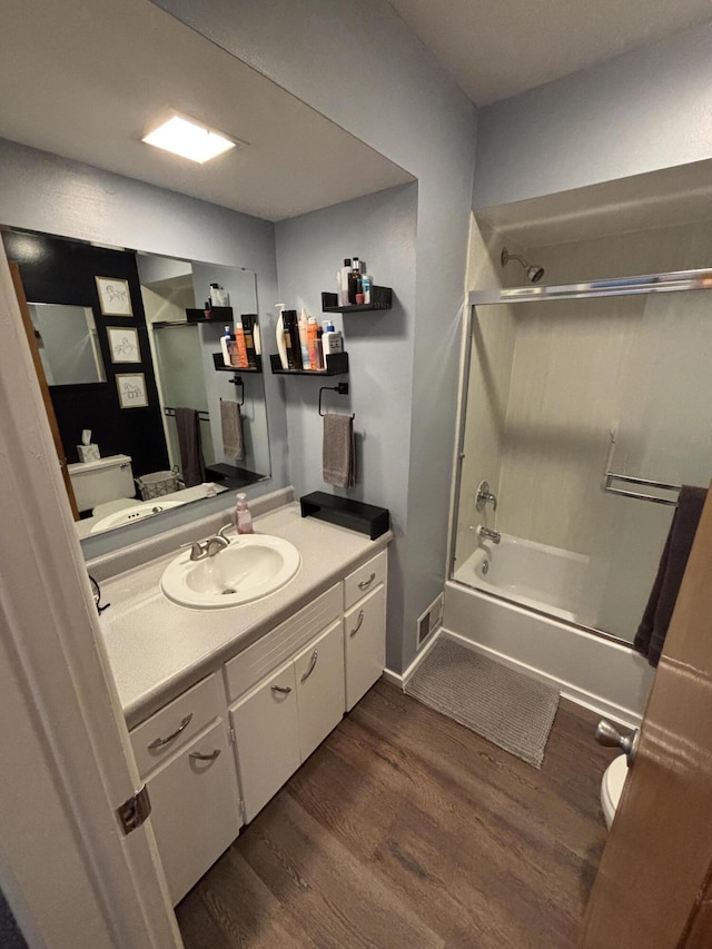 full bath with toilet, vanity, shower / tub combination, and wood finished floors