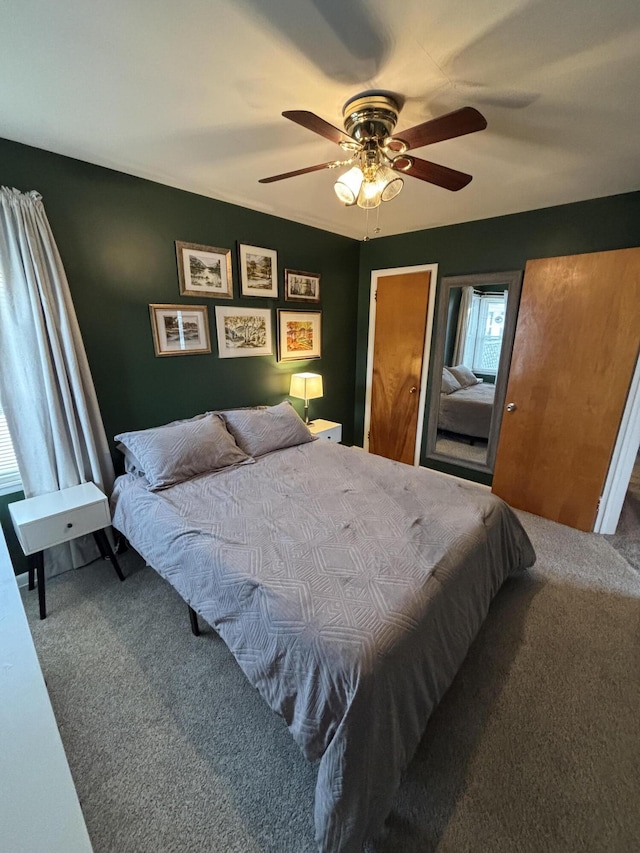 bedroom with a ceiling fan and carpet flooring