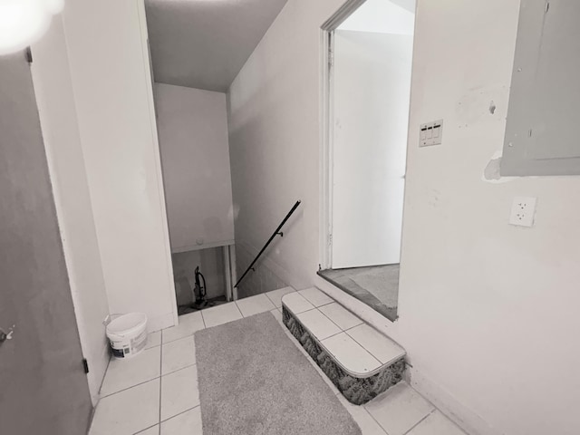 bathroom with electric panel and tile patterned flooring