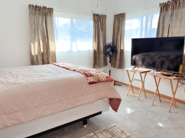 carpeted bedroom featuring baseboards