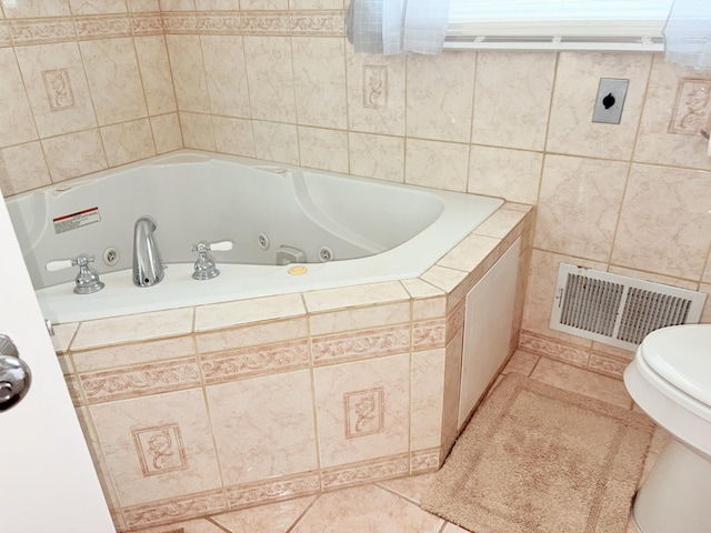 full bathroom featuring tile patterned flooring, toilet, visible vents, and a whirlpool tub