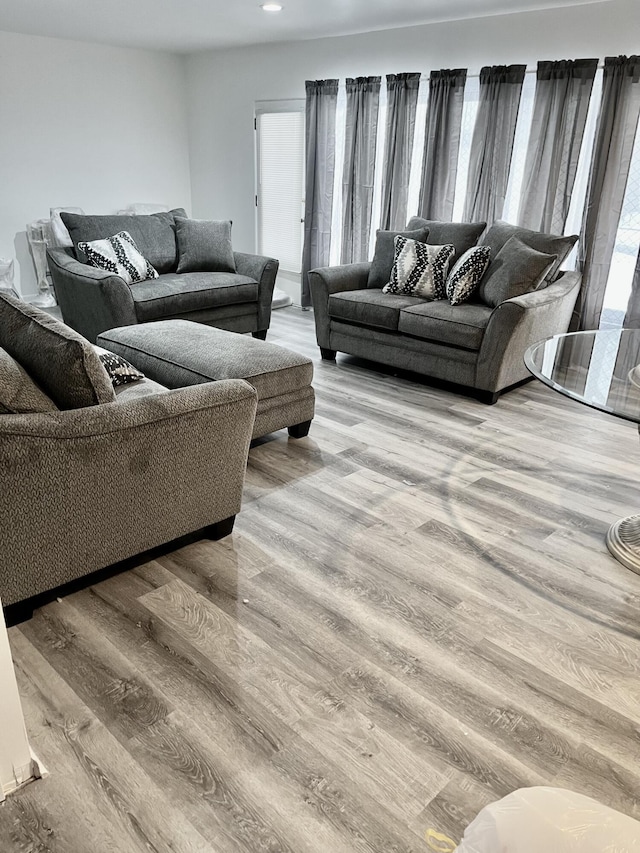 living room featuring a wealth of natural light, wood finished floors, and recessed lighting