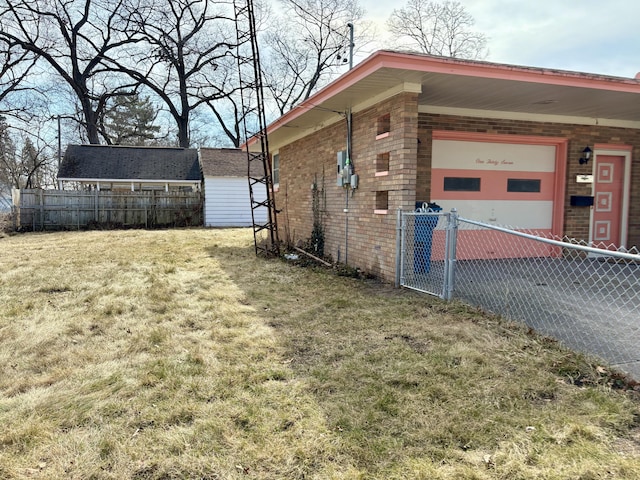 view of property exterior with aphalt driveway, fence, a yard, an attached garage, and brick siding