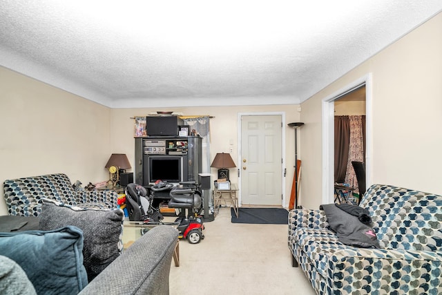 carpeted living room featuring a textured ceiling