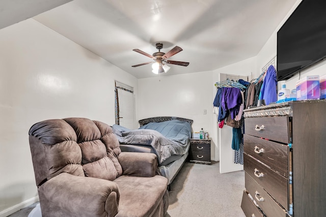 bedroom featuring light colored carpet and a ceiling fan