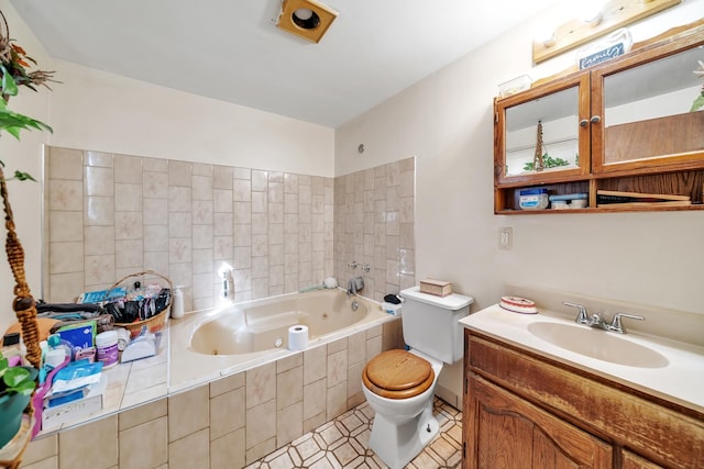 full bathroom with tile patterned flooring, toilet, a jetted tub, and vanity