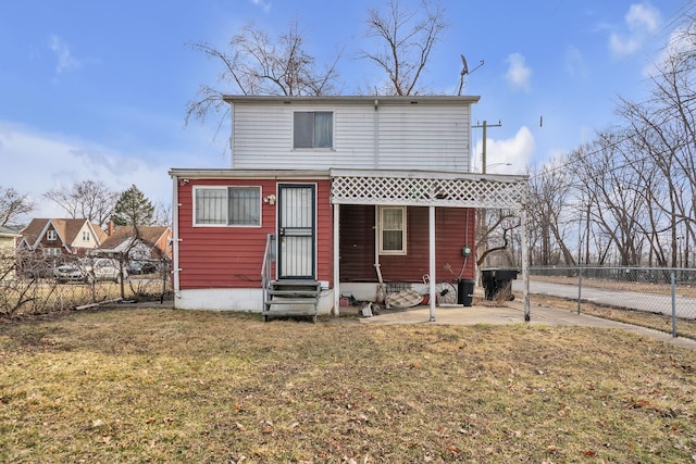 view of front of house with entry steps, a front yard, and fence