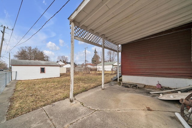 view of patio with an outbuilding and a fenced backyard