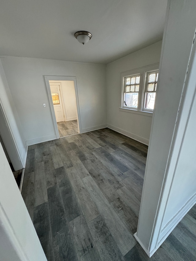 interior space with baseboards and wood finished floors