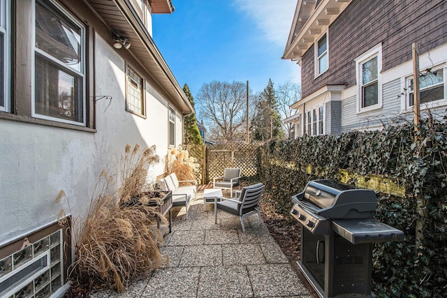 view of patio / terrace featuring fence and a grill