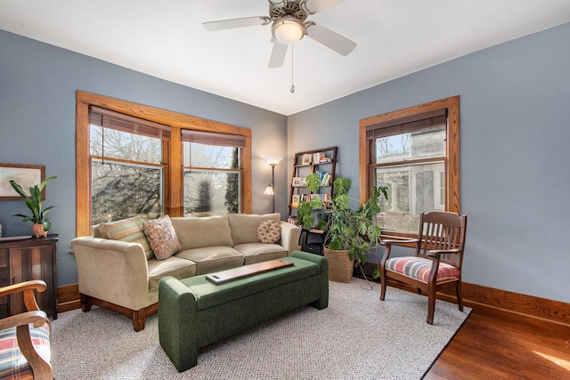 living room with plenty of natural light, ceiling fan, baseboards, and wood finished floors