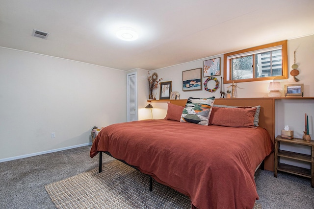 carpeted bedroom featuring a closet, visible vents, and baseboards