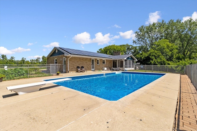 view of pool featuring a diving board, a fenced in pool, a patio, and fence