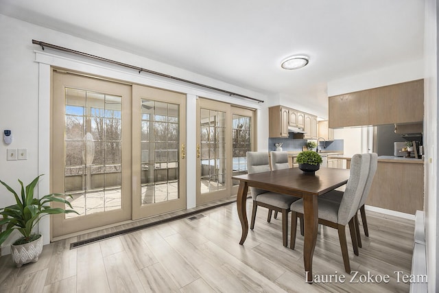 dining room with light wood finished floors