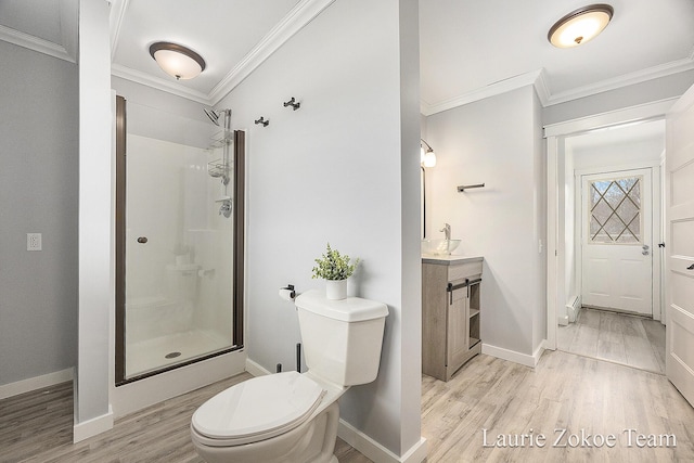 full bath with ornamental molding, toilet, wood finished floors, and walk in shower