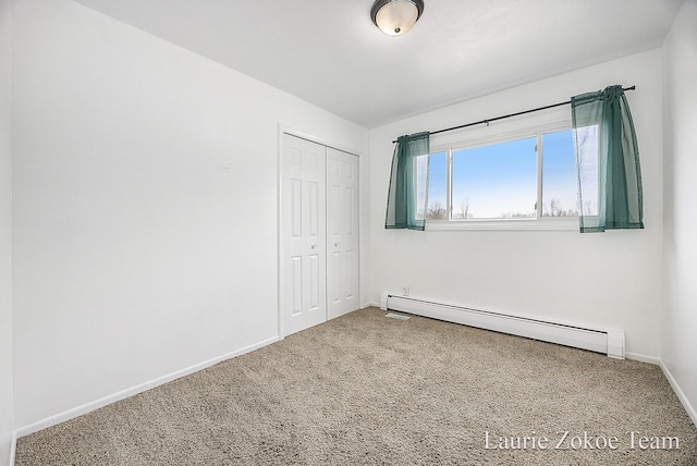 unfurnished bedroom with a closet, baseboards, baseboard heating, and carpet flooring