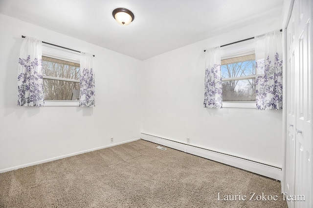 carpeted spare room with baseboards and baseboard heating