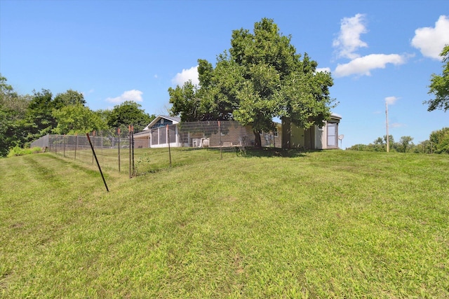 view of yard with an outbuilding and fence