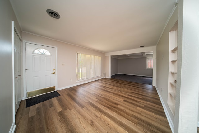 entryway featuring visible vents, baseboards, wood finished floors, and crown molding