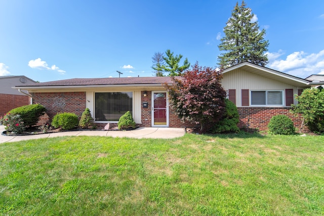 ranch-style home with brick siding and a front lawn