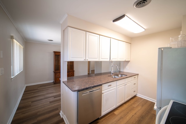 kitchen with dark wood-type flooring, stainless steel dishwasher, freestanding refrigerator, white cabinetry, and range