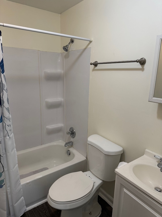 bathroom with vanity, wood finished floors, toilet, and shower / bathtub combination with curtain