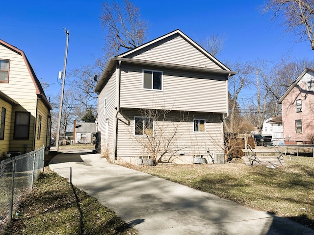 view of side of property featuring fence and driveway