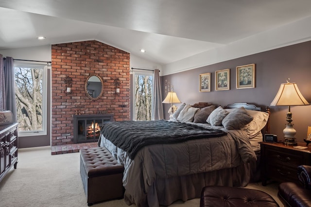 carpeted bedroom with recessed lighting, a fireplace, and vaulted ceiling