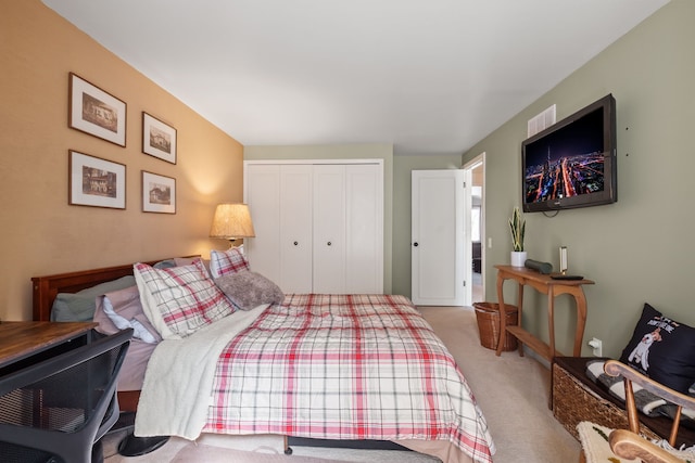 carpeted bedroom with a closet and visible vents