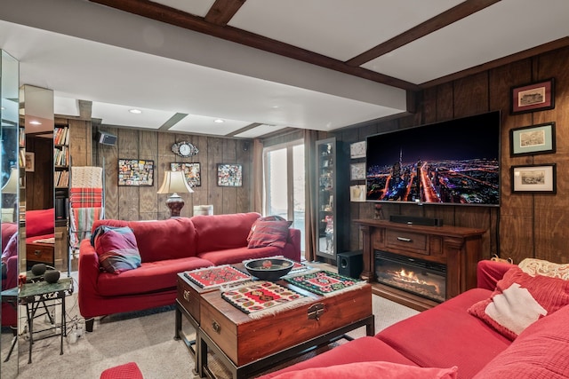 living room featuring carpet flooring, beamed ceiling, and wood walls