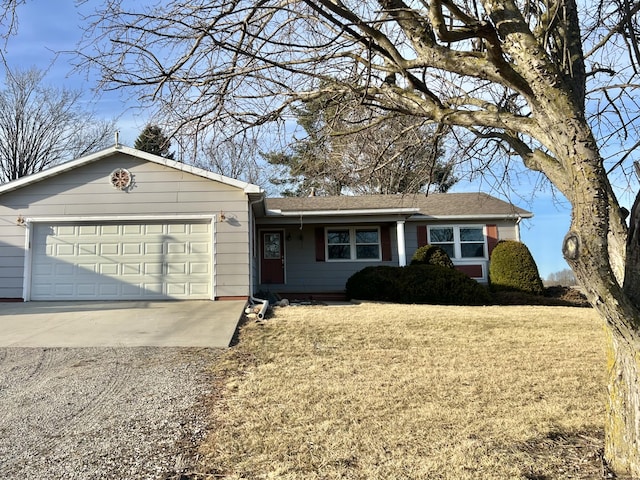 ranch-style home featuring a front yard, an attached garage, and driveway