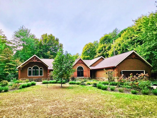 view of front of property with a front lawn and an attached garage