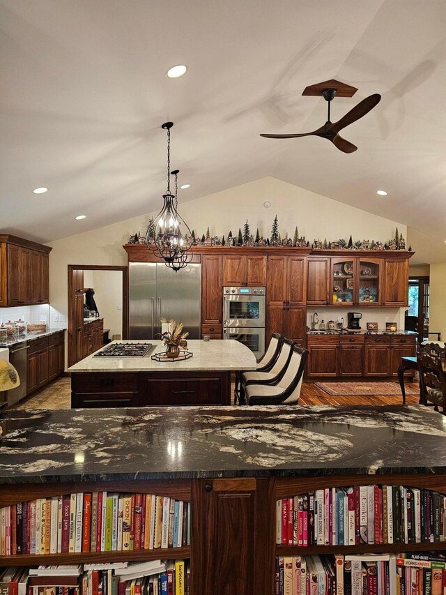 interior details featuring recessed lighting, ceiling fan with notable chandelier, and stainless steel appliances