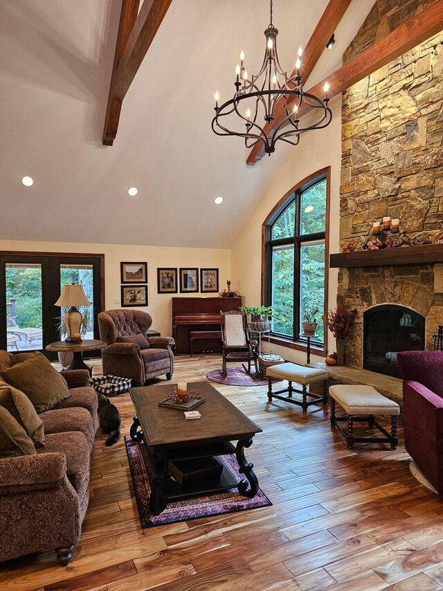 living area featuring a stone fireplace, recessed lighting, high vaulted ceiling, and hardwood / wood-style floors