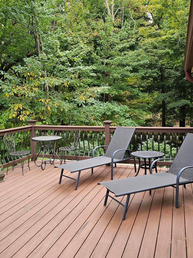 wooden deck with a forest view