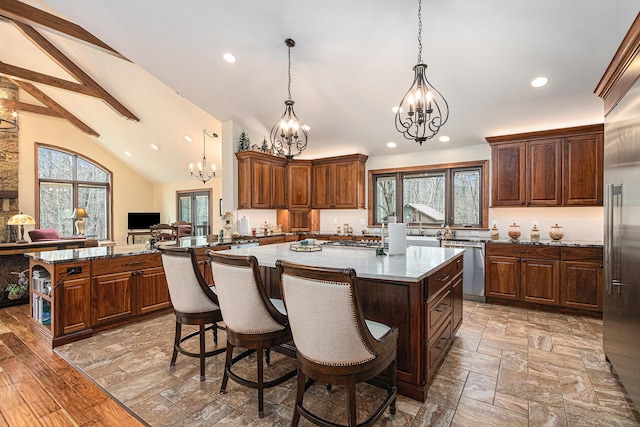 kitchen with a chandelier, a center island, open floor plan, and stainless steel appliances