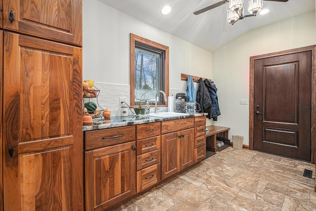 bathroom with visible vents, ceiling fan, lofted ceiling, and vanity