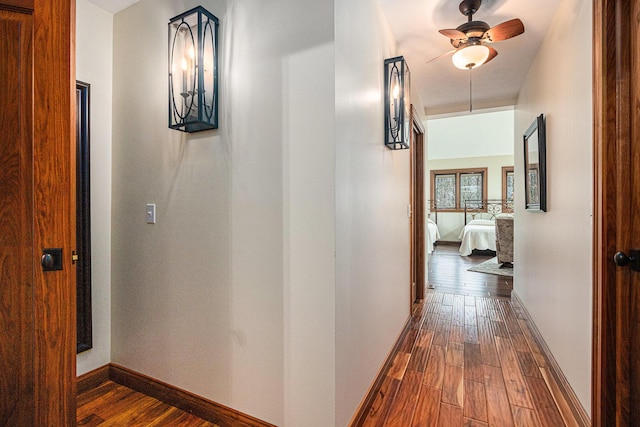 hall with baseboards and dark wood-style floors