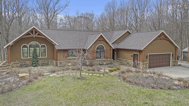 rustic home with an attached garage, a shingled roof, driveway, and a front lawn