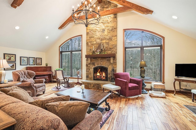 living room featuring an inviting chandelier, wood finished floors, and a healthy amount of sunlight