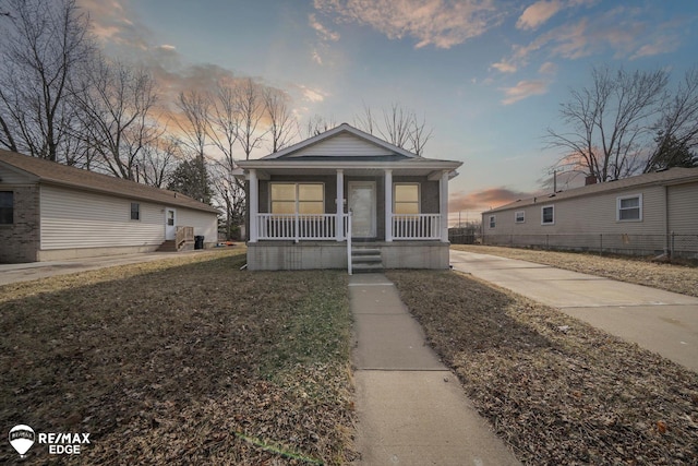 shotgun-style home featuring covered porch