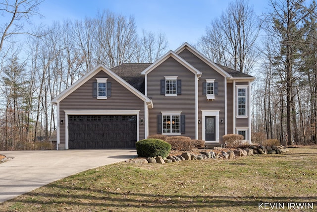 view of front of house with a front lawn, a garage, and driveway