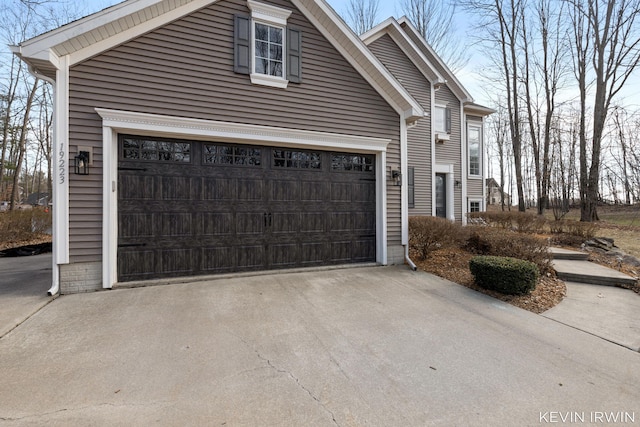 view of property exterior with driveway and a garage