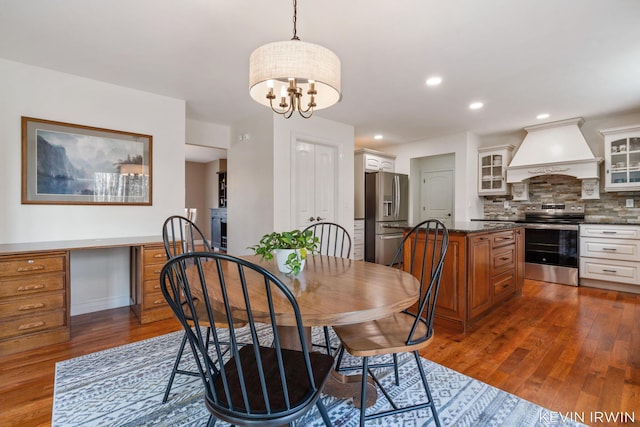 dining space with recessed lighting, a fireplace, and dark wood-type flooring