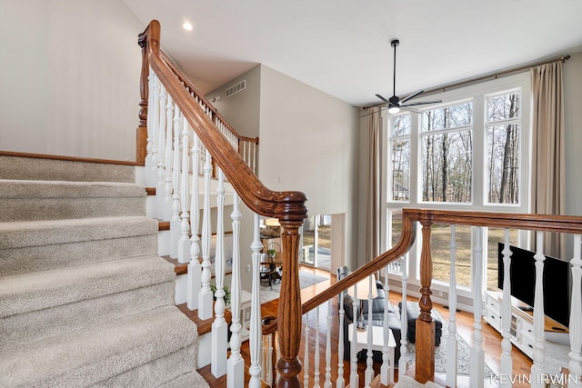 stairway with recessed lighting, visible vents, wood finished floors, and a ceiling fan